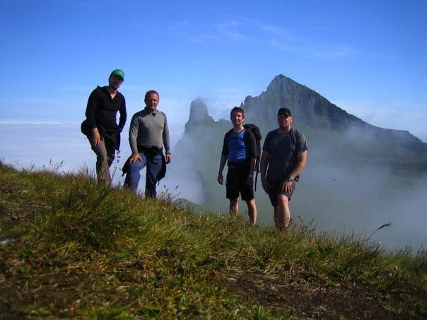 A group of friends at Hornbjarg Cliff with Kálfatindar in the background