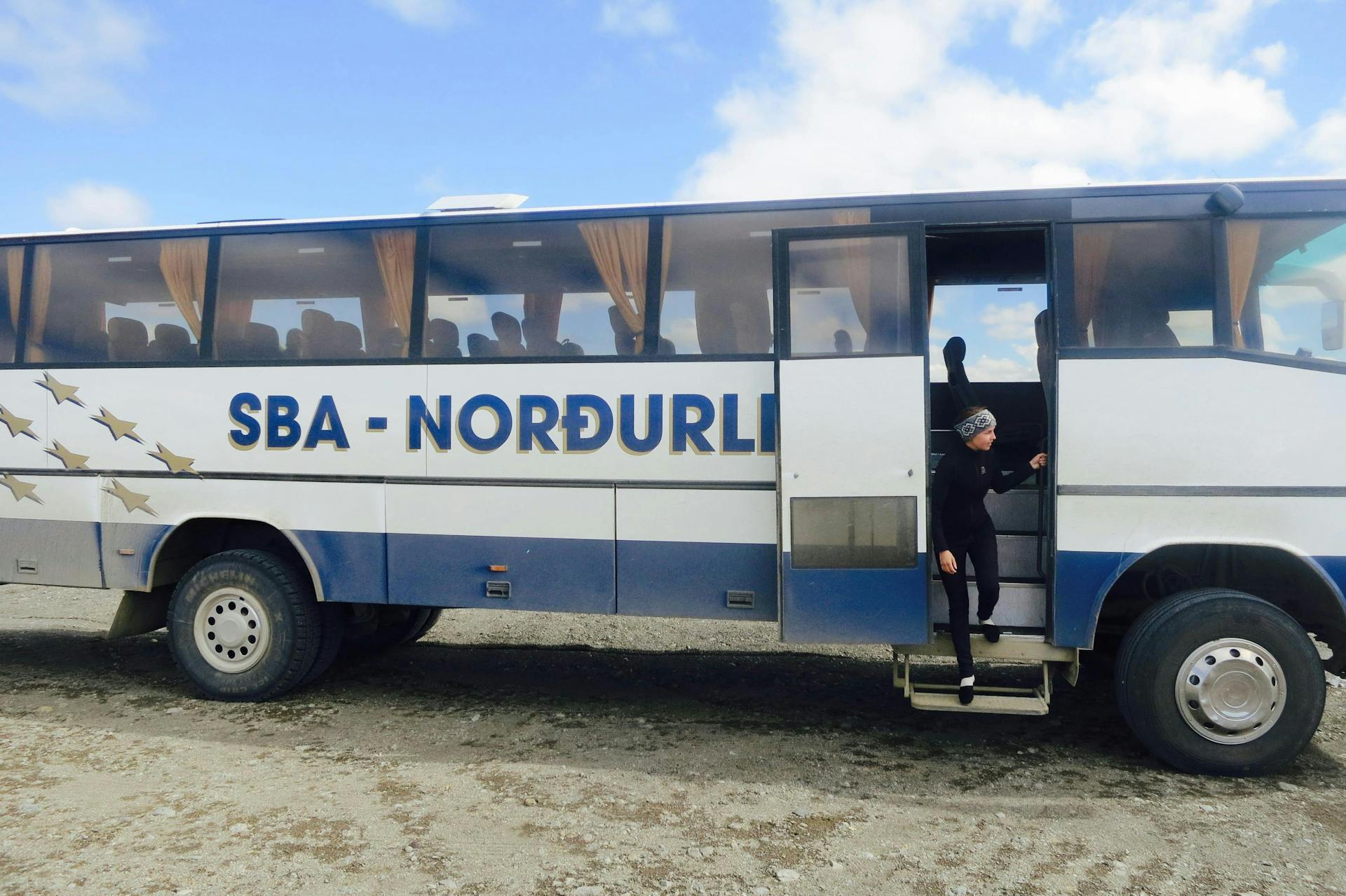 A woman stepping out of a bus in the Iceland Highlands. 