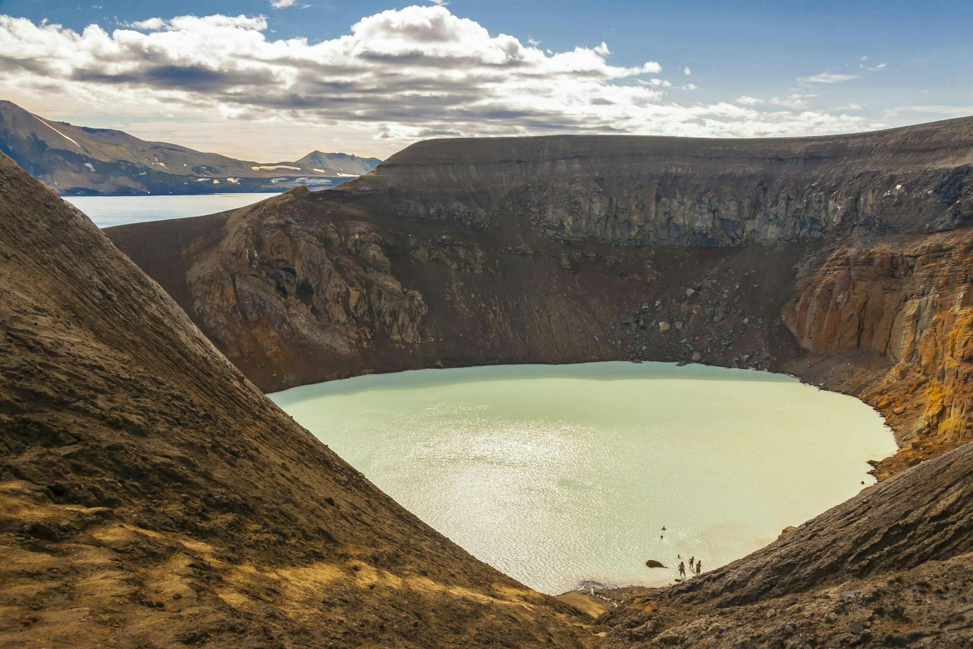 A crater filled with light blue water. 