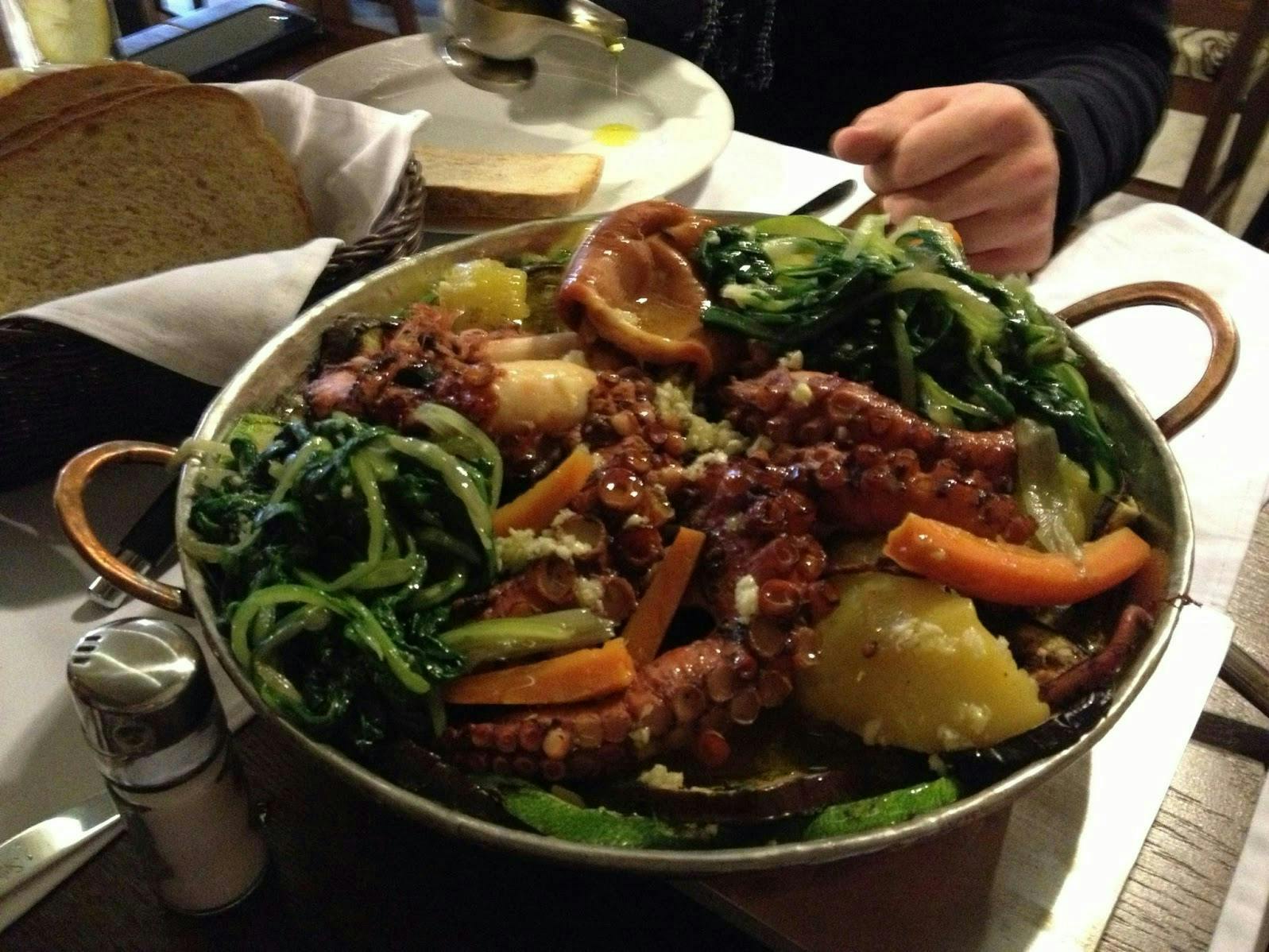 A big bowl of octopus and vegetables. 