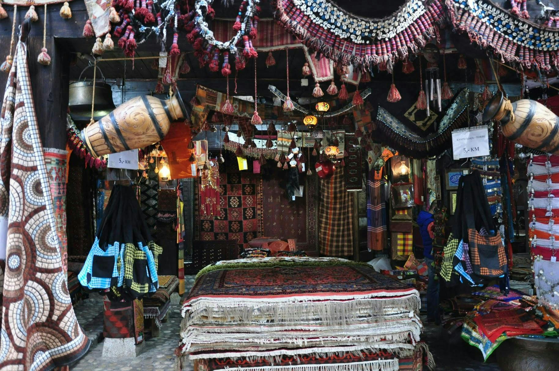 A market with oriental rugs and other things. 