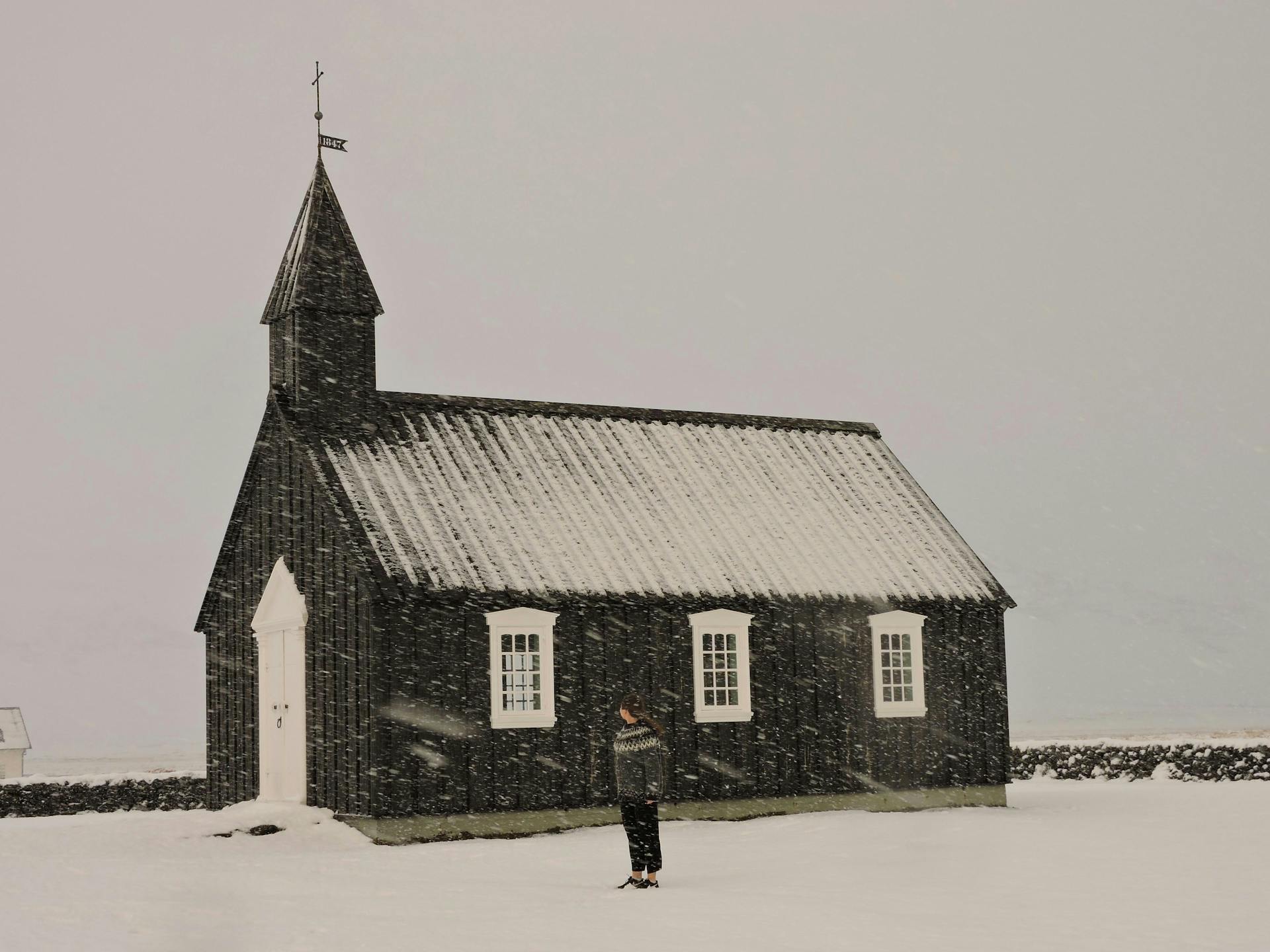 A black church at Búðir, Snæfellsnes, with some snow on the roof. 