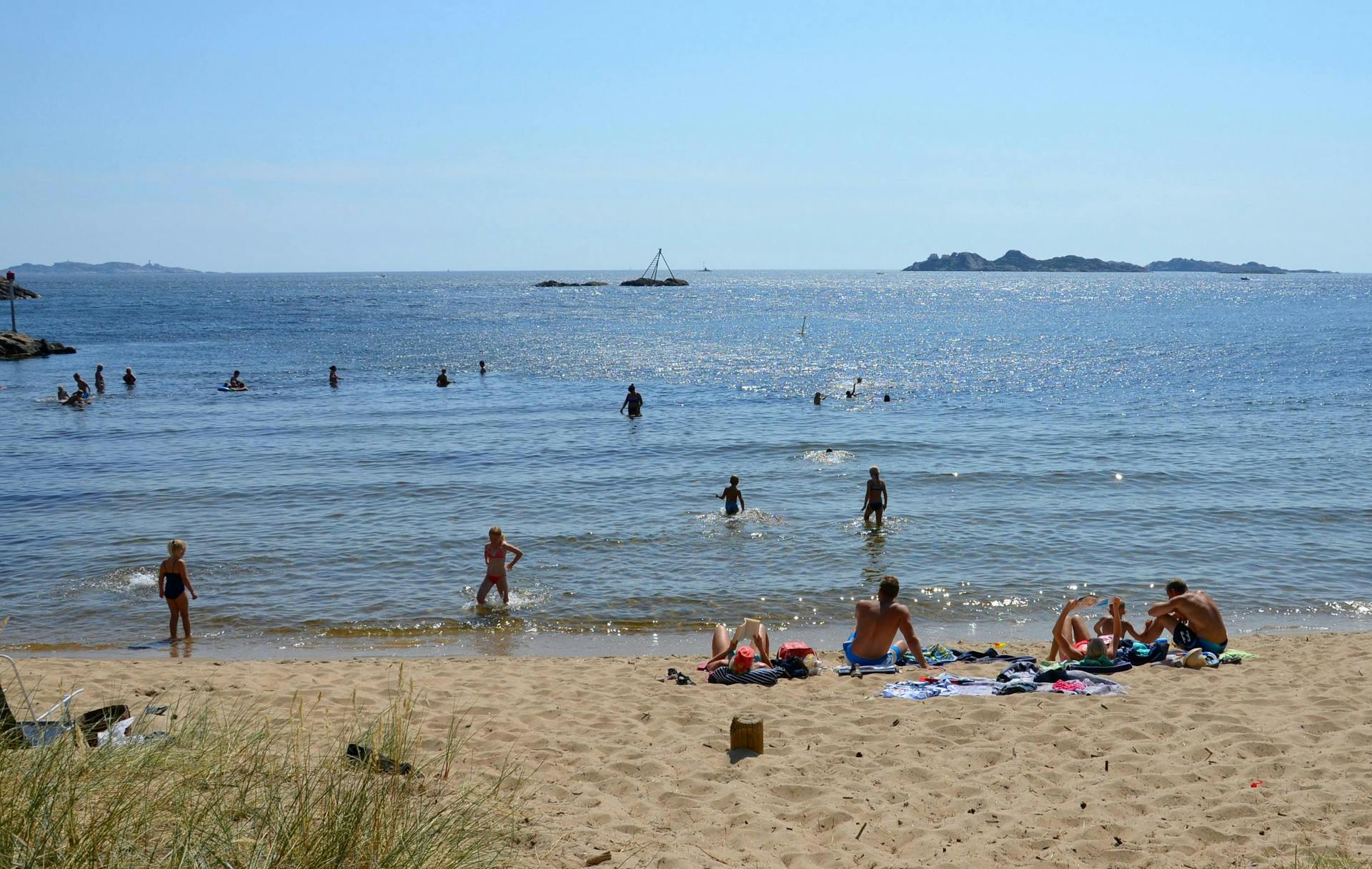 People swimming in the sea and enjoying the beach. 