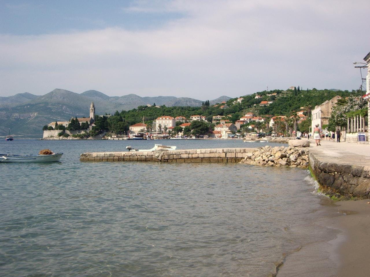 The seaside of Elafitis Islands, trees and houses in the background. 