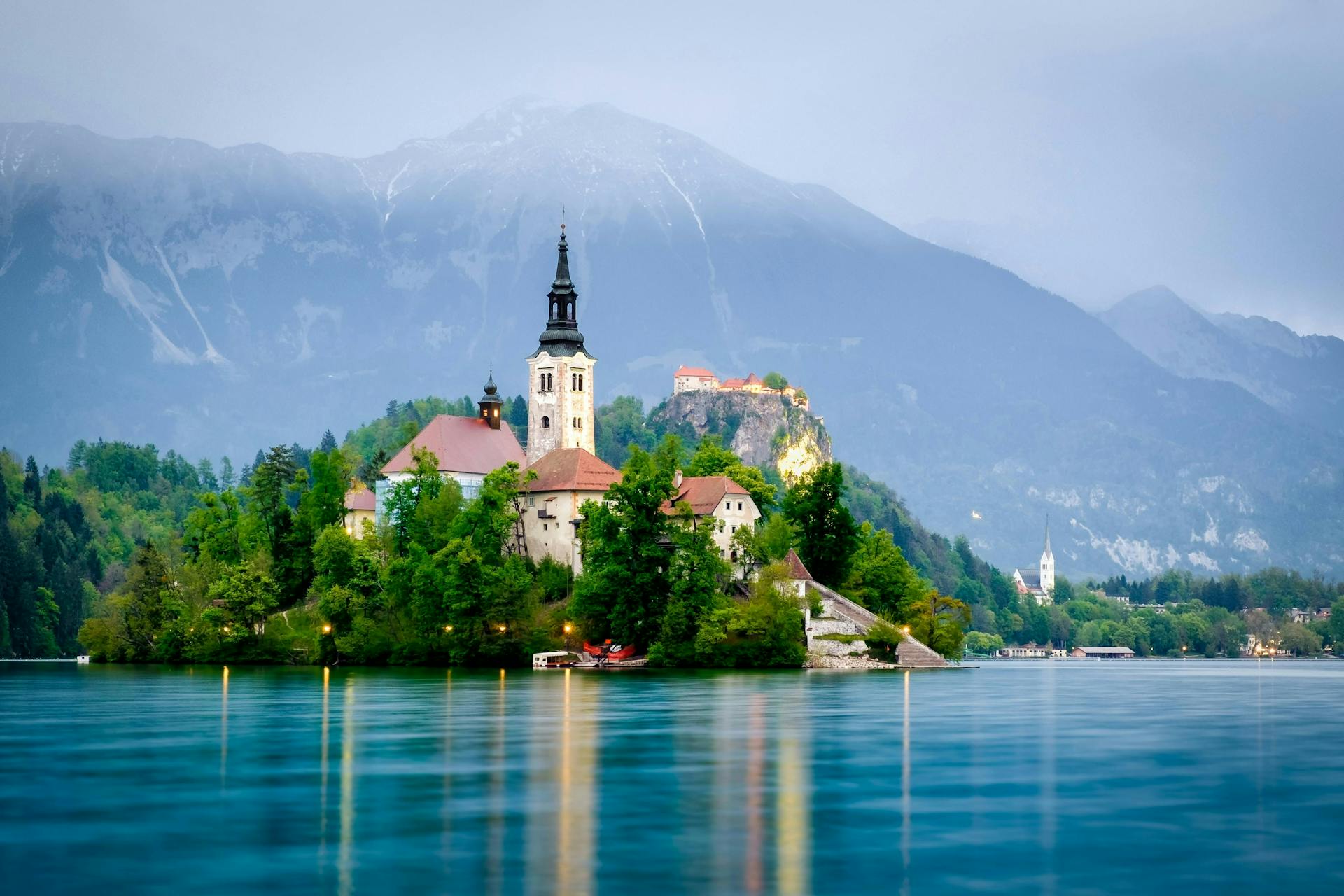 An islet with houses and trees on Lake Bled. 