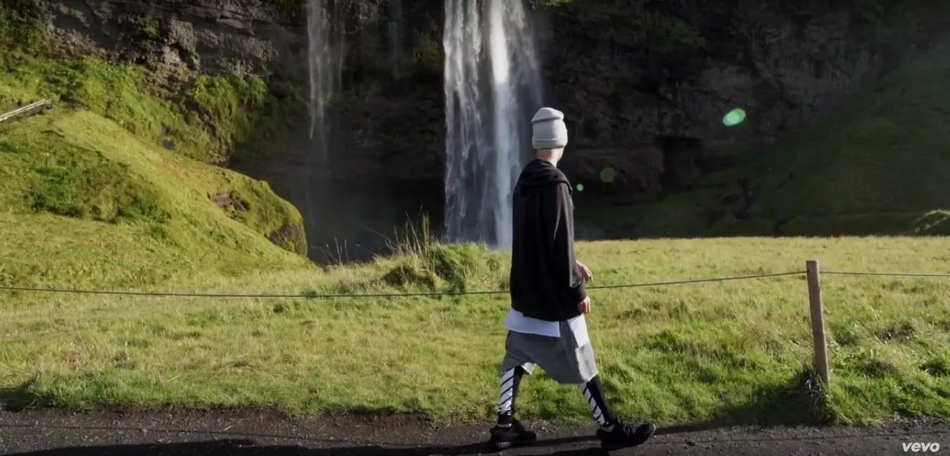 Justin Bieber walking in front of Seljalandsfoss