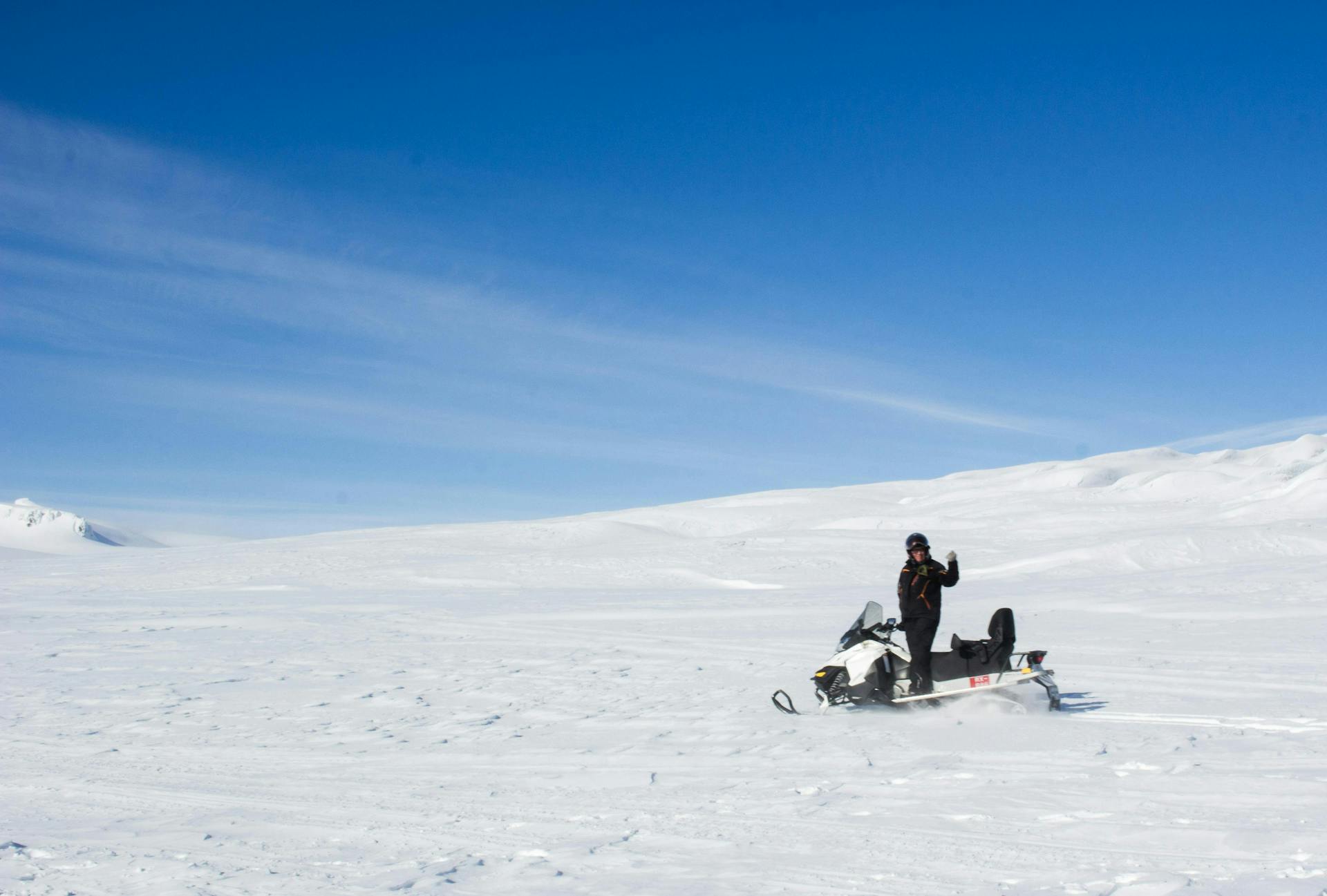 A man snowmobiling on an Icelandic glacier