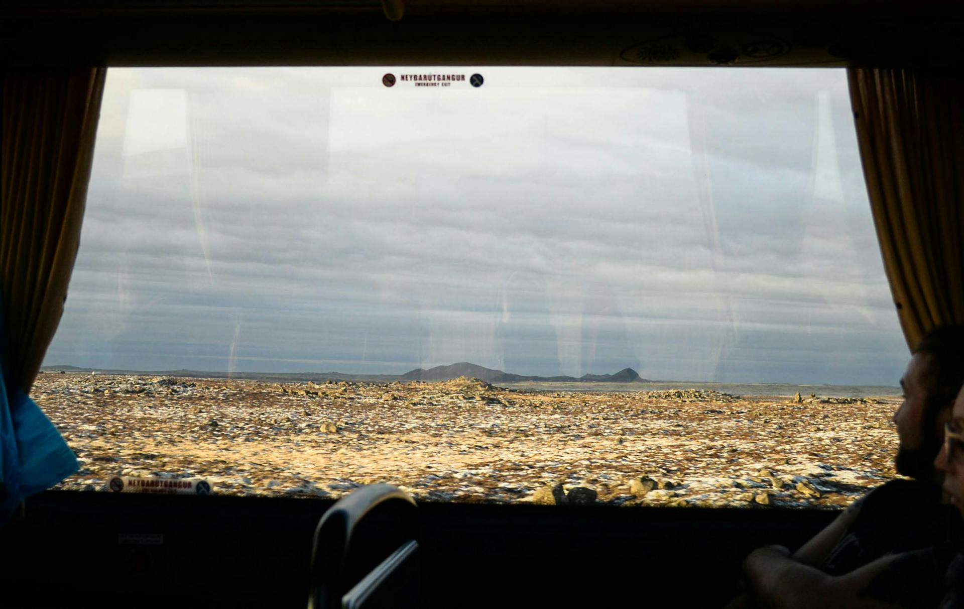 View through window on a shuttle bus of the Icelandic countryside