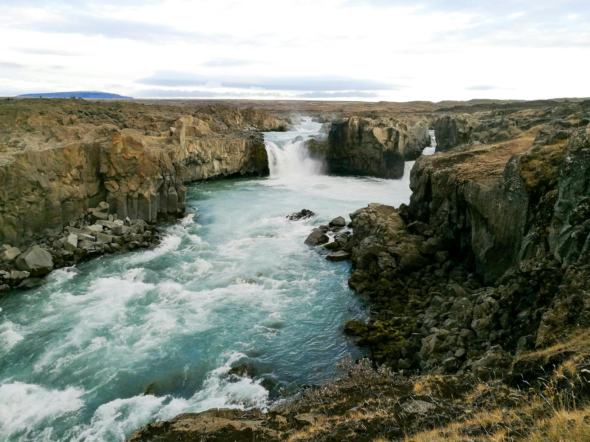 Hiking around the canyon in Aldeyjarfoss waterfall in north Iceland