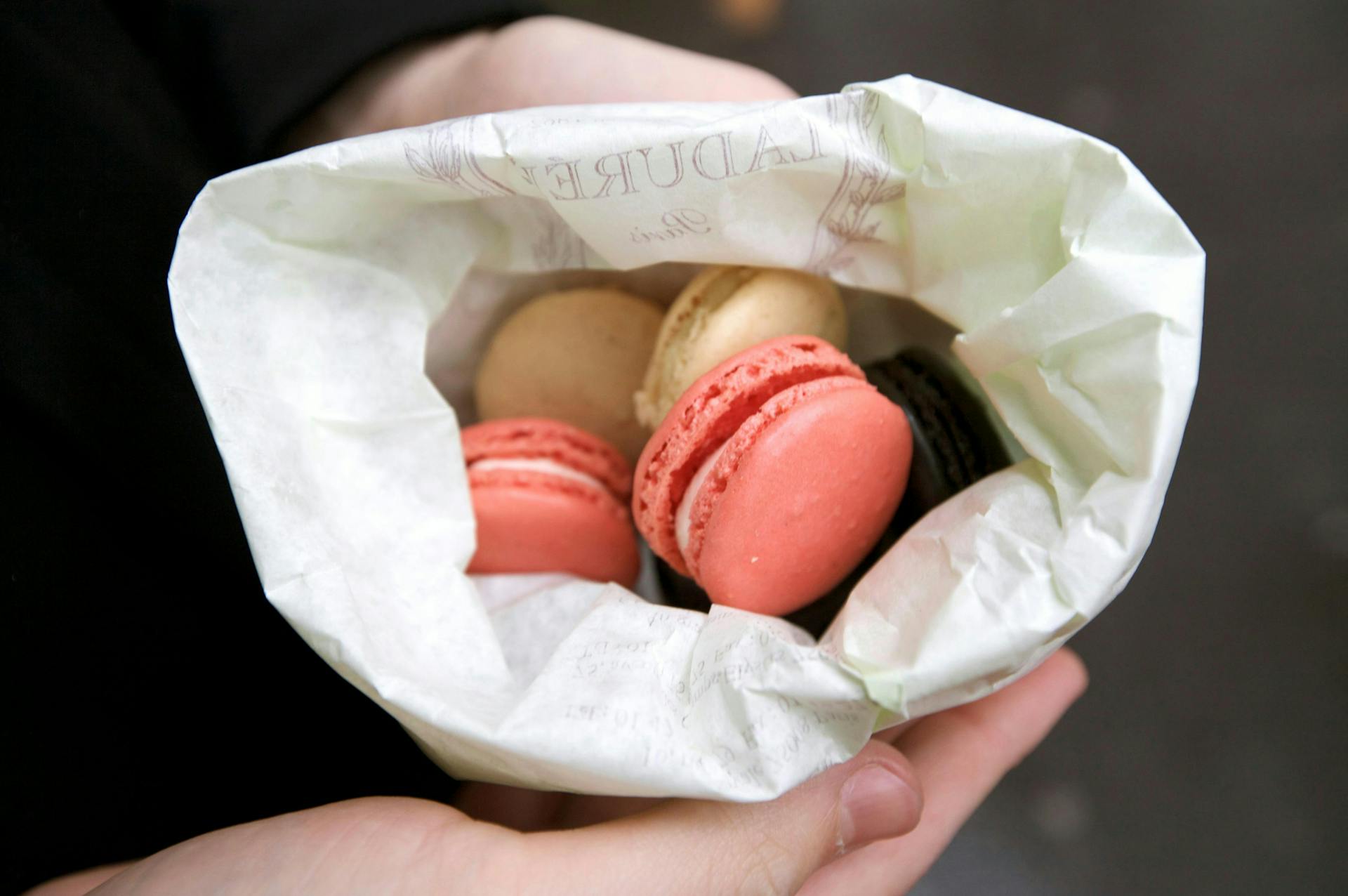 Two macarons in a paper bag. 