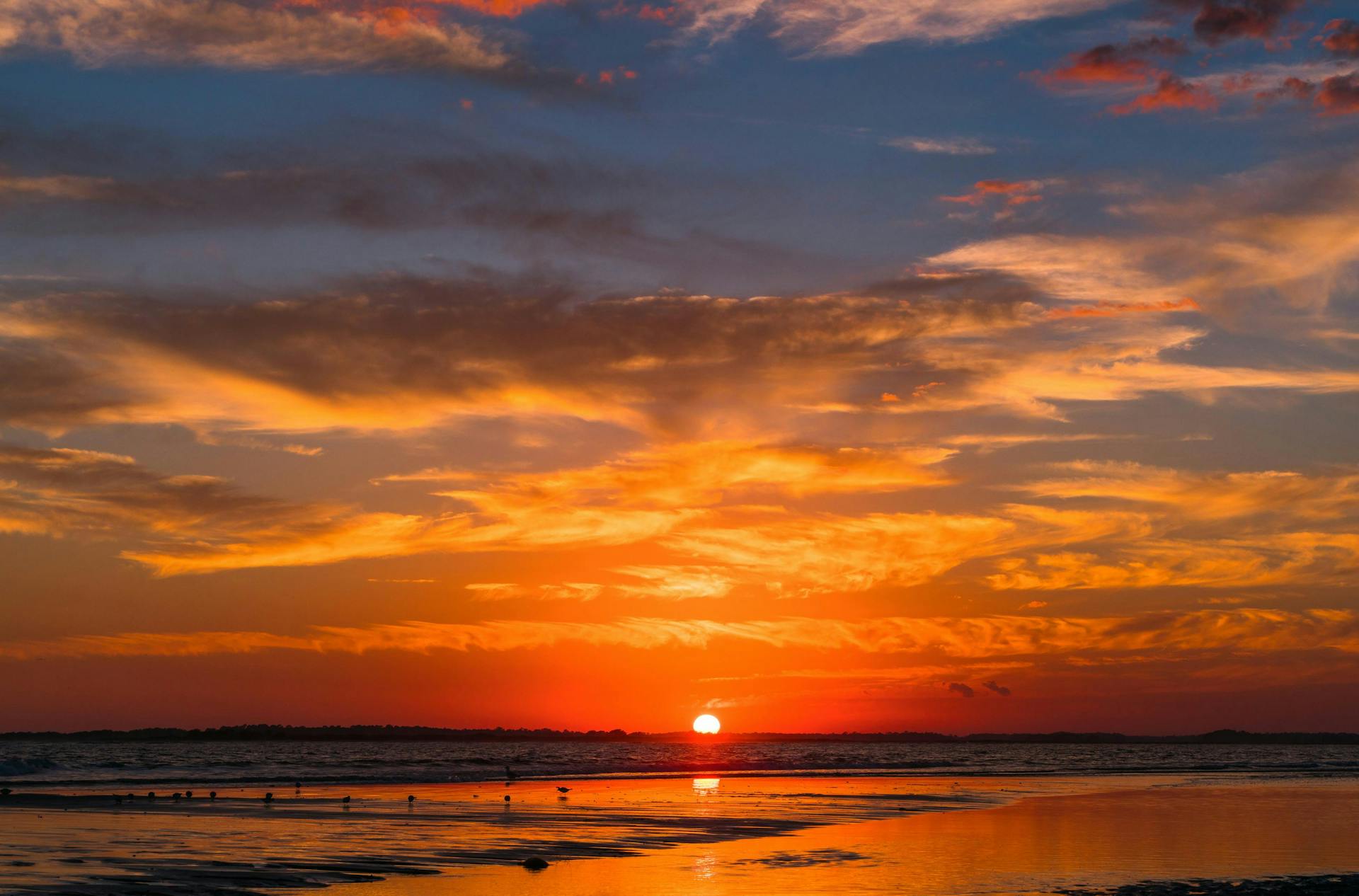 Bright orange sunset on the Folly Beach in South Carolina. 